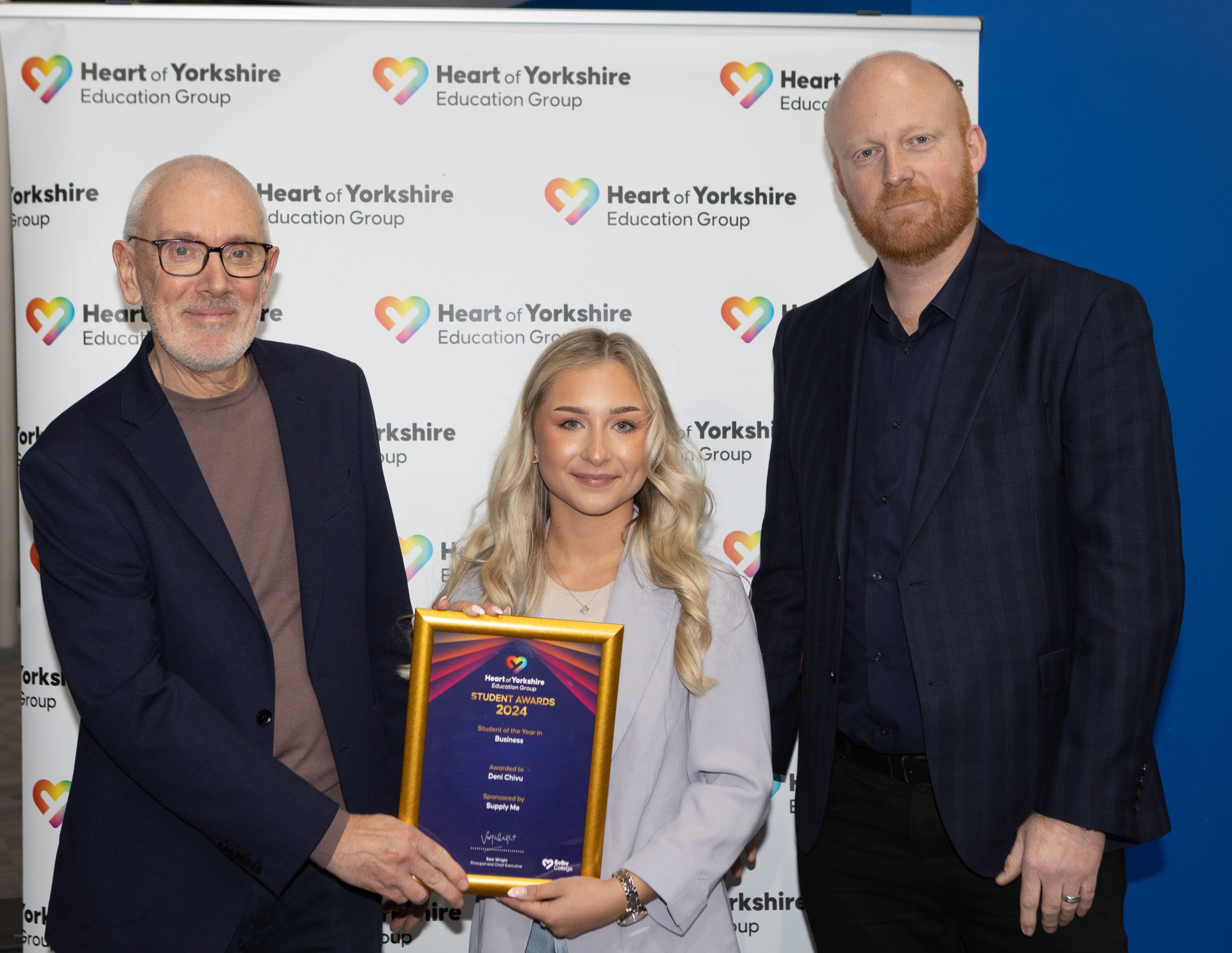 Andrew McConnell OBE (left) and Matthew Rennison, Operations Director at Supply Me (right), presenting Deni Chivu with her award
